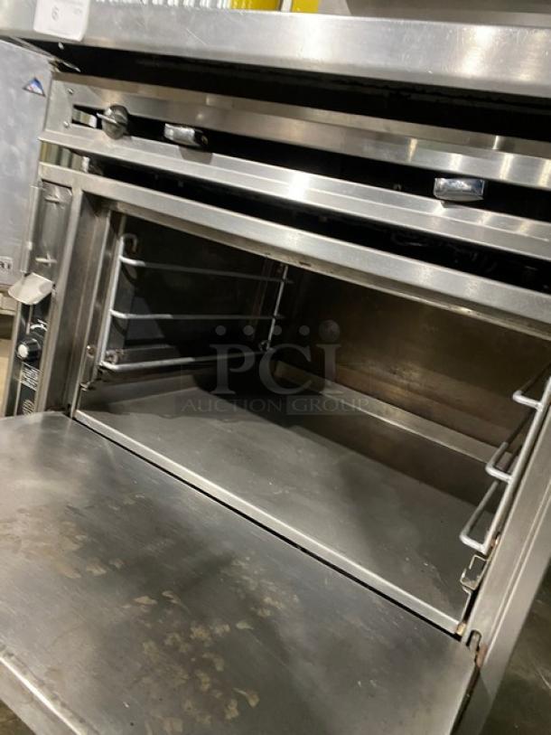 Jade Range stainless steel commercial gas range with plancha top, backsplash, salamander broiler, and universal wire slide.