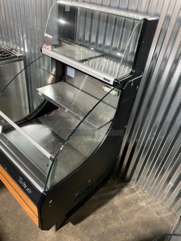Turbo Air TOM-30LB refrigerated merchandiser display case, black with stainless steel interior, overhead dry display, dual sliding doors.
