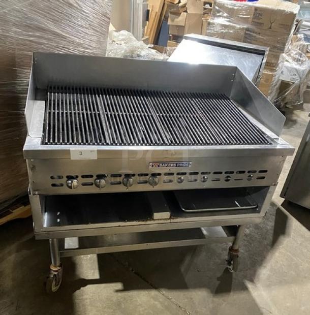 Bakers Pride stainless steel gas char broiler with back & side splash, single undershelf, on casters, excellent condition.
