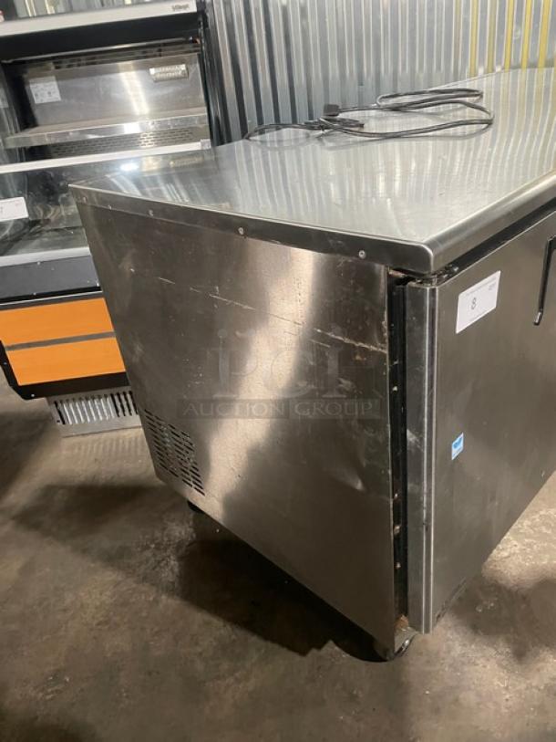 Everest ETBR3 stainless steel 3-door undercounter refrigerator with poly-coated rack, SN: BTBR317030062, 115V, on casters.