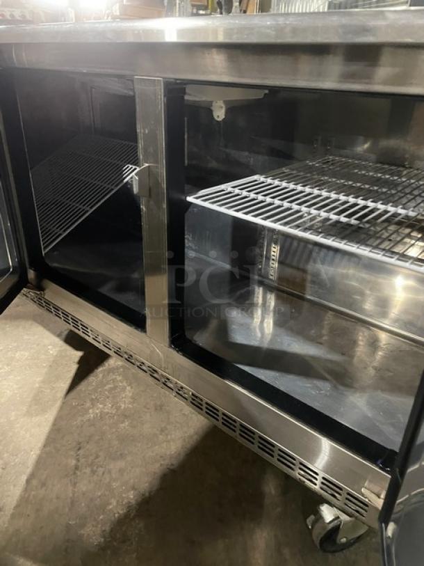 Everest ETBR3 3-Door Undercounter Refrigerator, stainless steel, poly-coated racks, casters, 115V, commercial use.