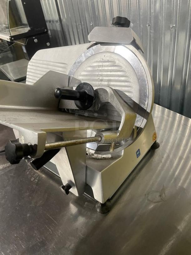 Univex commercial electric countertop meat slicer on legs, metal construction, adjustable blade, used condition.