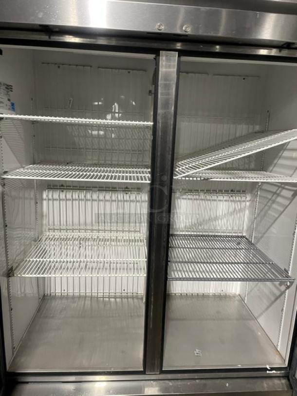 True T-49F commercial stainless steel 2 door reach-in freezer with poly coated wired racks, Energy Star certified, on casters.