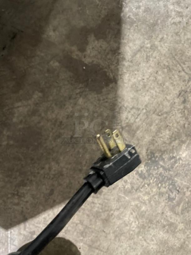 Close-up of a power plug for the True T-49F commercial freezer, model T-49F, 115V, 1 phase.