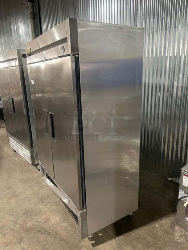 True T-49F commercial stainless steel 2-door reach-in freezer with poly-coated racks, on casters, 115V, 1 phase.