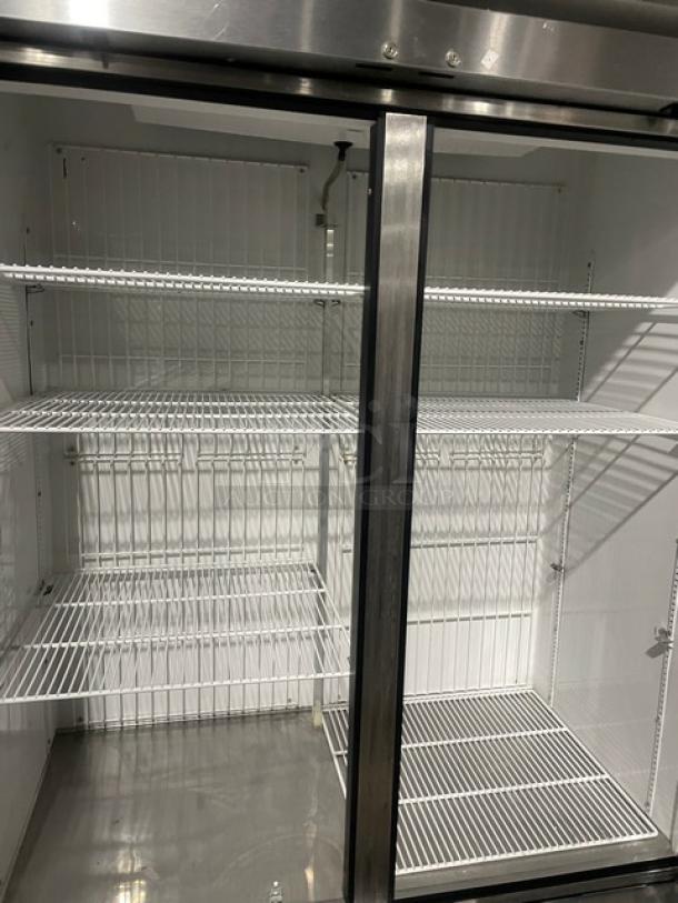 True T-49F commercial stainless steel 2-door reach-in freezer with poly-coated wire racks, on casters, 115V, 1 phase.