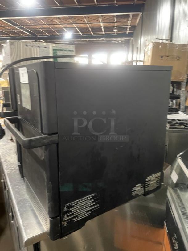 MerryChef commercial black electric countertop oven, late model, rapid cook. Visible wear. Safety and usage labels on side.