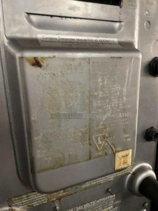 MerryChef commercial black electric countertop oven, late model. Visible wear and faded labels. High-speed rapid cook feature.