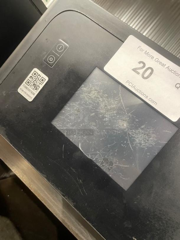 Late model MerryChef commercial black electric countertop rapid cook oven with touchscreen. Visible wear on screen.