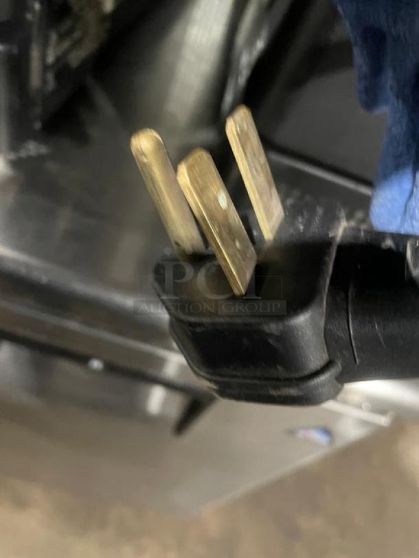 Close-up of a black electrical plug from a MerryChef commercial high-speed rapid cook oven.