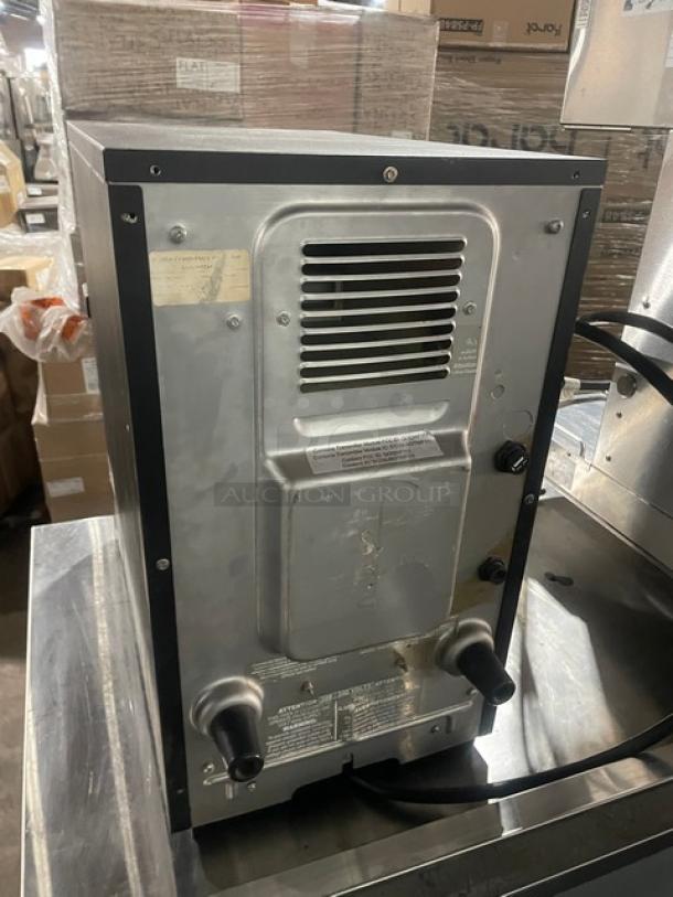 MerryChef commercial black electric rapid cook oven, late model. Features metallic finish, vent, and power cables; tags visible.