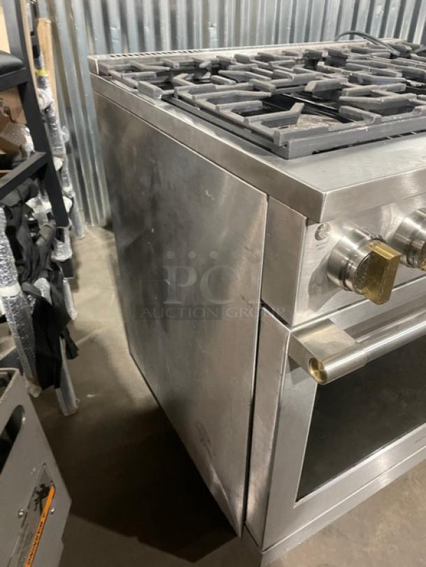 Monogram commercial stainless steel gas range/oven combo, 6-burner, wired oven rack, on legs, sturdy condition.