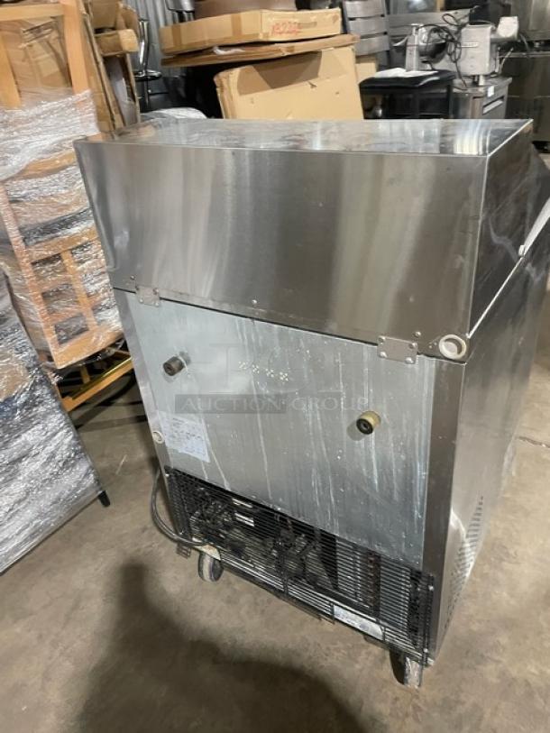 Turbo Air MST-28-12 refrigerated prep table, stainless steel, single door, on casters, rear view.