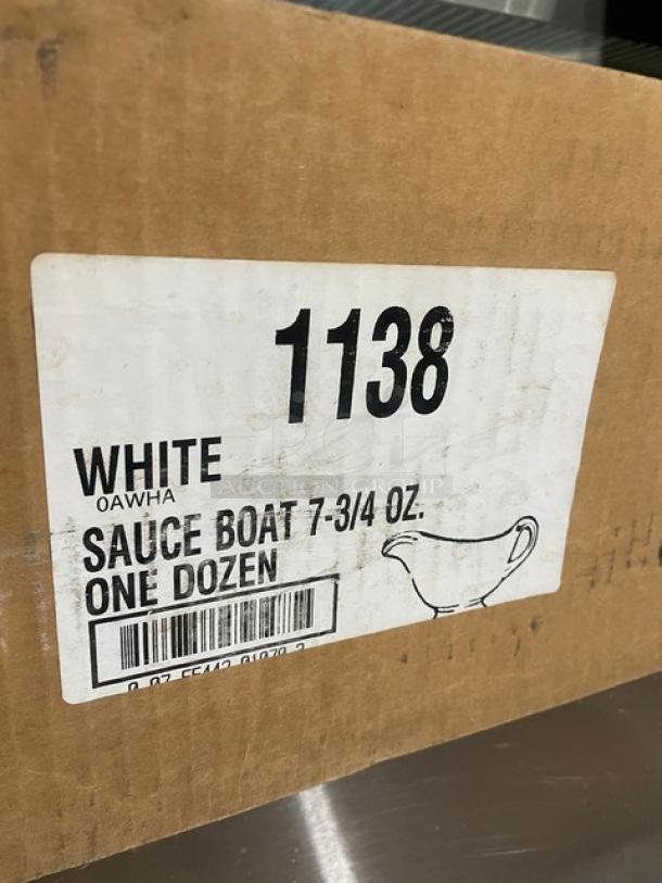 Cardboard box labeled "1138 White 7-3/4 Oz. Sauce Boat, One Dozen." New commercial sauce/gravy boats in a case.