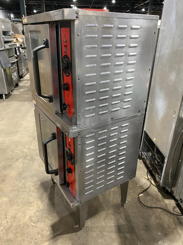 Vulcan commercial stainless steel double stack gas convection oven with wired rack, mounted on legs; features control knobs.