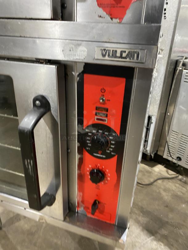 Vulcan commercial stainless steel gas double-stacked convection oven with wired rack, control panel visible, mounted on legs.