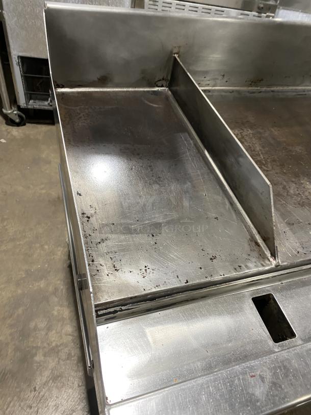 WoodStone stainless steel gas plancha griddle with back and side splash. Mounted on welded stand with casters, in used condition.