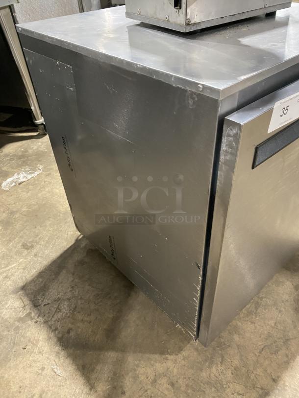 Delfield 406CA-DD1 stainless steel undercounter refrigerator, single door, model 406CADD1, with poly-coated wire racks, on casters.