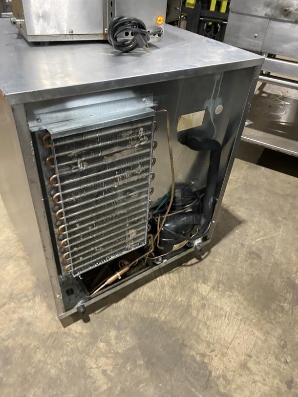 Delfield 406CADD1 stainless steel single-door undercounter refrigerator on casters, shown with poly-coated wire racks, 115V.