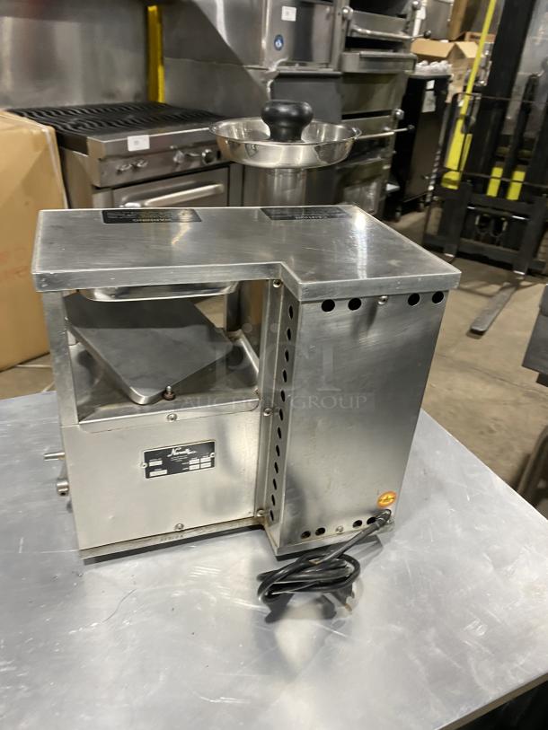 Norwalk Model 275SS commercial stainless steel juicing machine, countertop two-stage cold press, visible model label, power cord.