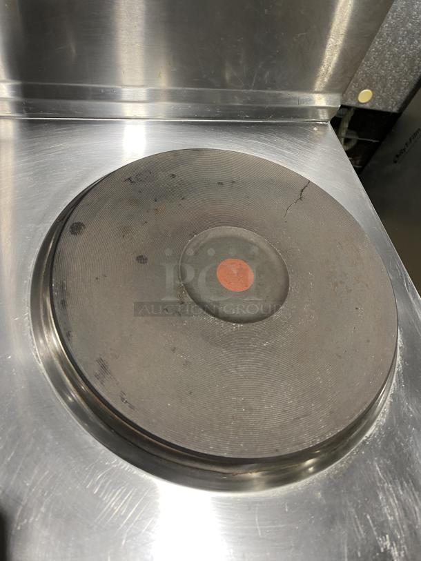 Cookline ER24208 stainless steel 4-burner range top. Visible wear, circular heating element with a red center mark.