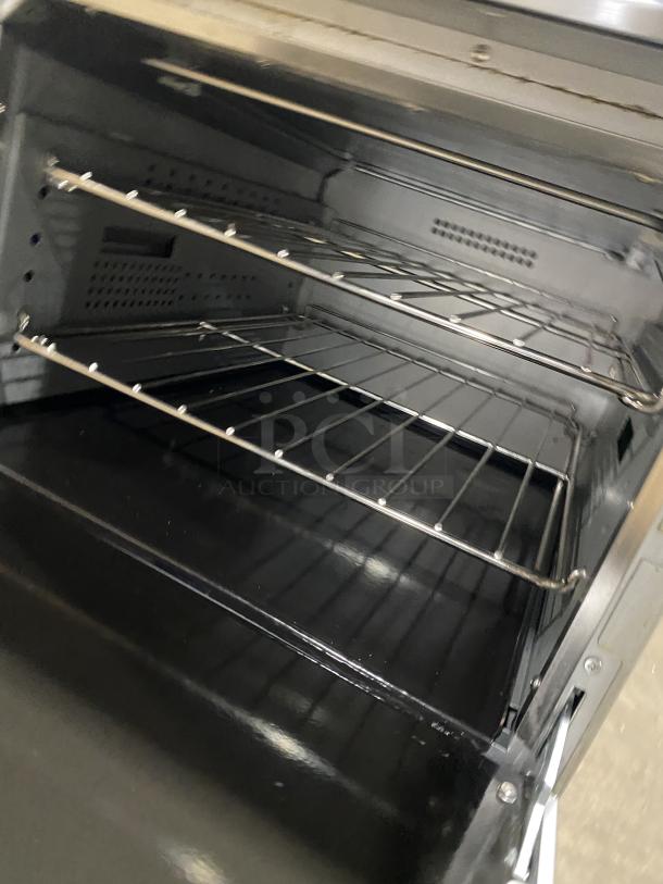 Cookline stainless steel range/oven interior with wired racks, Model ER24-208, 4 burners, electric, 208V, on legs.