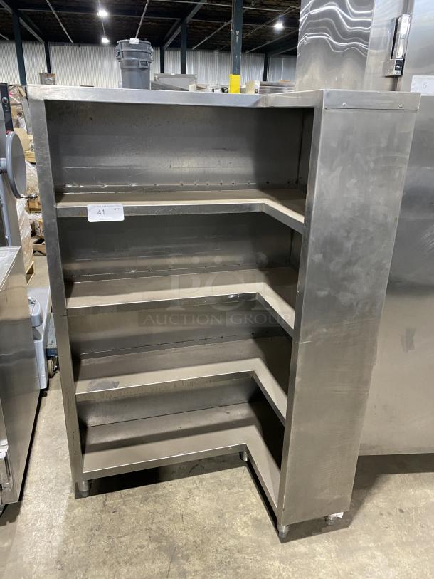 Commercial stainless steel open front cupboard unit on legs with four shelves. Used condition, no visible tags or labels.