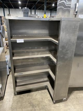 Commercial stainless steel open front cupboard unit on legs with four shelves. Used condition, no visible tags or labels.