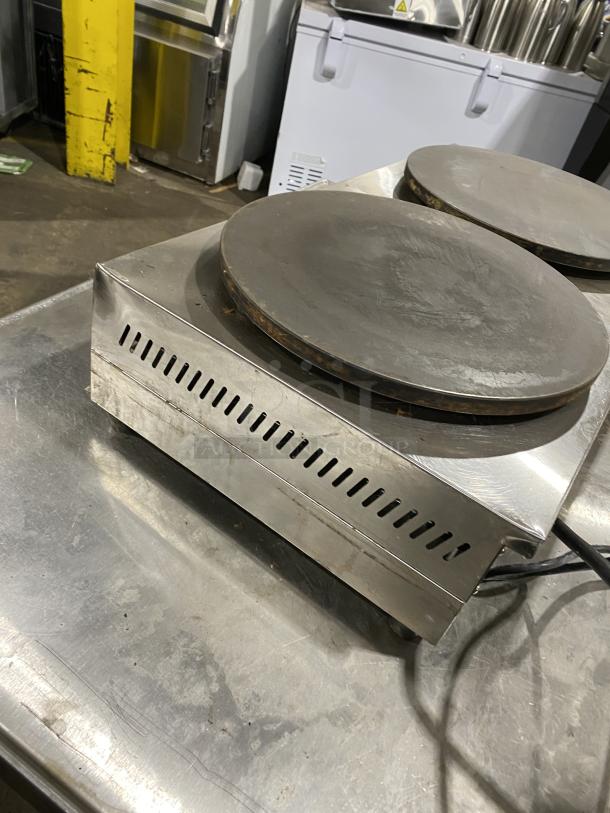 Commercial stainless steel electric double crepe maker, model DE-2, 110V. Used condition with two round cooking surfaces.