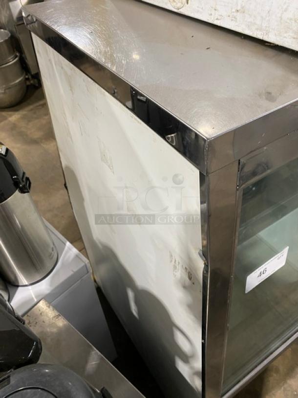 Custom Cool DEL4SC stainless steel deli merchandiser display case, 48", slanted glass, condition shows wear. Rear glass doors, model and serial number labels visible.