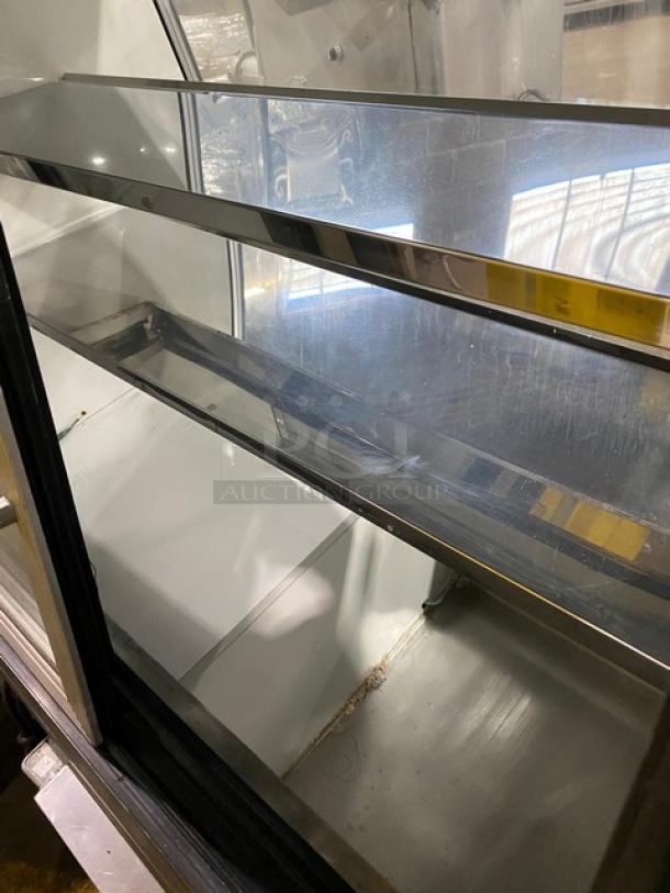 Custom Cool DEL4SC 48" refrigerated merchandiser with stainless steel, slanted glass, dual glass sliding doors, and storage.