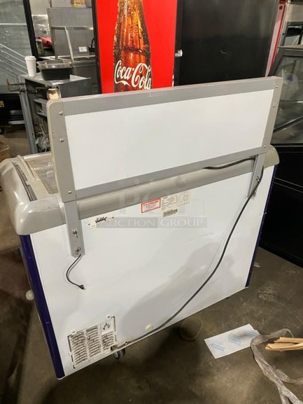 Excelente CF-289 curved top commercial ice cream freezer, 2018 model, with sliding glass top, wire baskets, on casters.