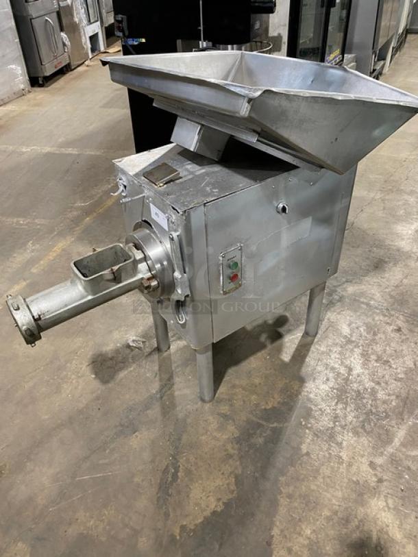 Hobart commercial heavy-duty meat grinder, electric-powered, free-standing, high capacity, durable metal body, mounted on legs.