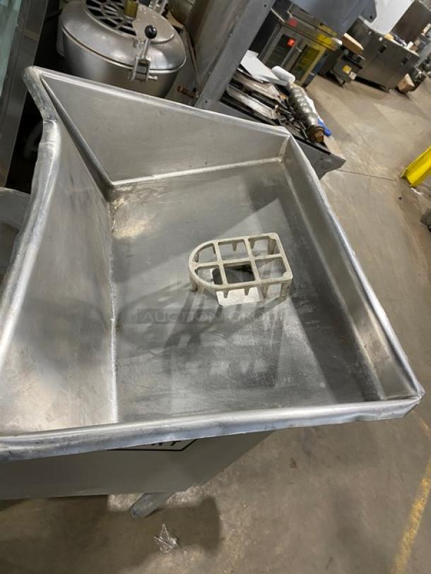 Hobart commercial meat chopper/grinder, heavy-duty, electric-powered, high capacity, free-standing on legs, metal construction.