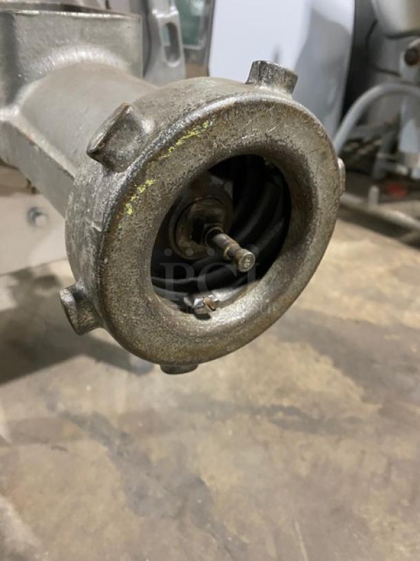 Hobart commercial electric meat grinder, heavy-duty, free-standing, visible metal construction, on legs, used condition.