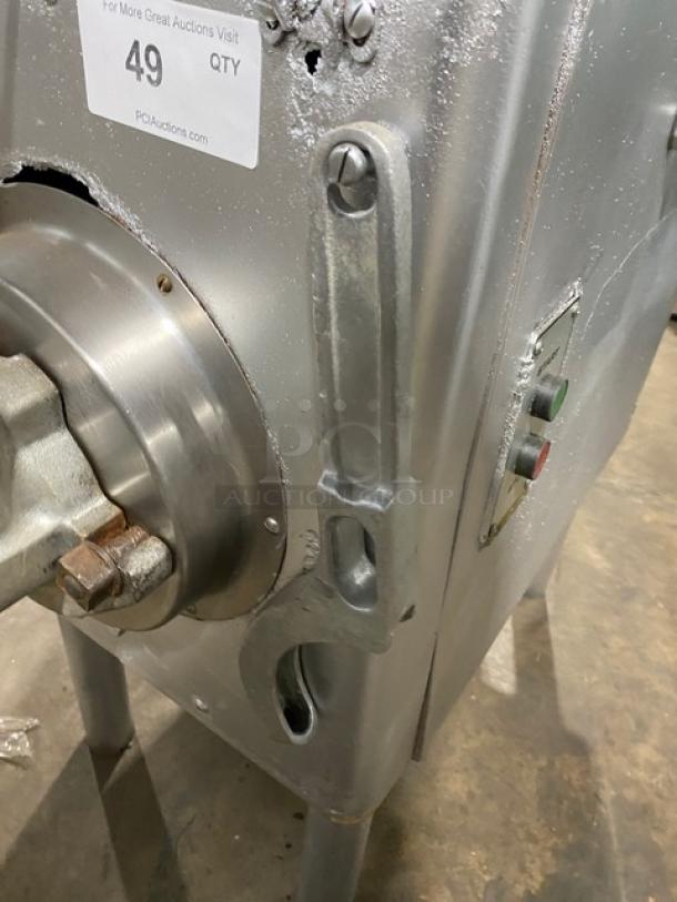 Hobart commercial electric meat grinder, heavy-duty, freestanding on legs, visible wear, buttons for operation.