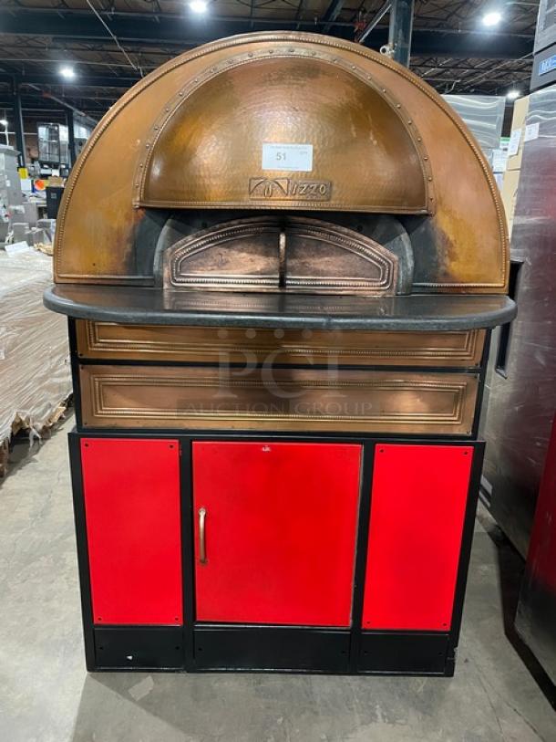 Izzo Forni red dome-style electric pizza oven with wooden paddle, commercial-grade, features durable construction and sleek design.