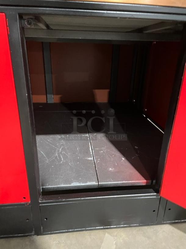 Izzo Forni red electric dome-style Napoletano pizza oven with open door. Includes a wooden pizza paddle. Good condition.