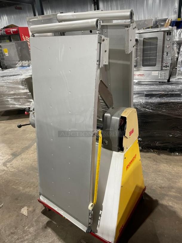 Seewer Rondo SS064C reversible dough sheeter in yellow. Features fold-up conveyor belt and casters. Model SS064C, SN A6019004.