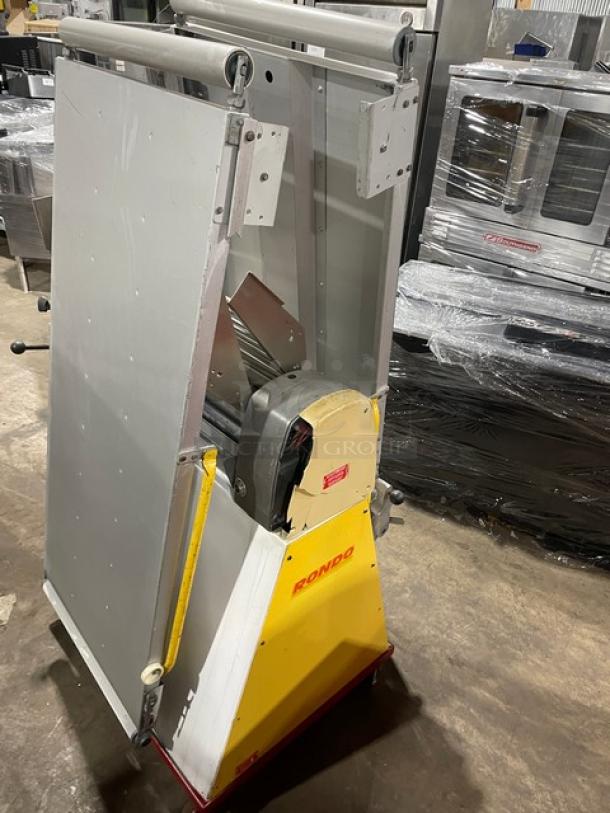 Seewer Rondo SS064C reversible dough sheeter, yellow, with fold-up conveyor belt and casters. Model SS064C, SN: A6019004.