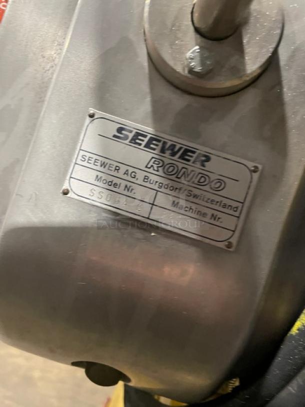 Seewer Rondo SS064C dough sheeter label, showing model and serial number, on metal surface.