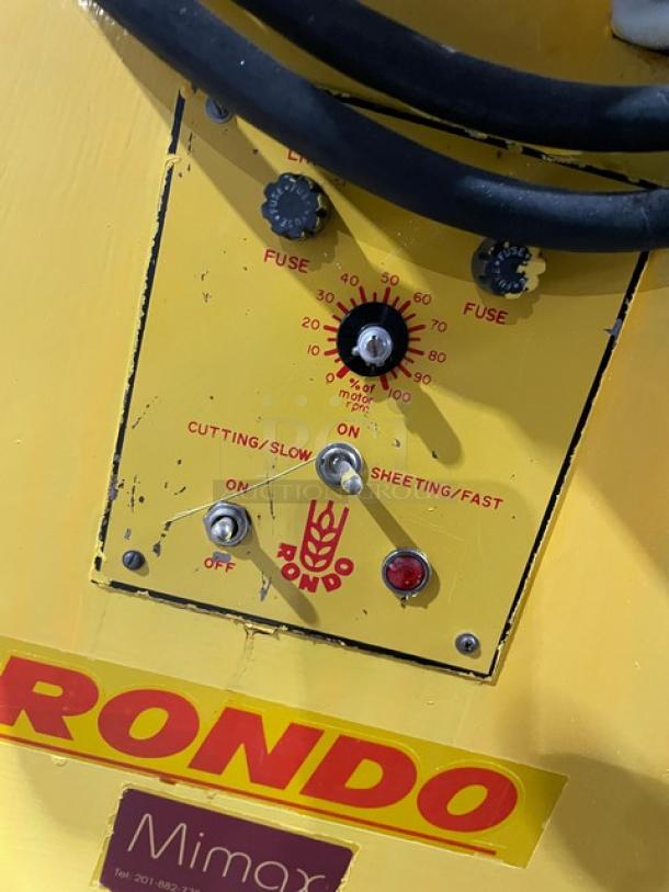 Seewer Rondo SS064C yellow electric dough sheeter, reversible, floor model with fold-up conveyor belt and controls, on casters.