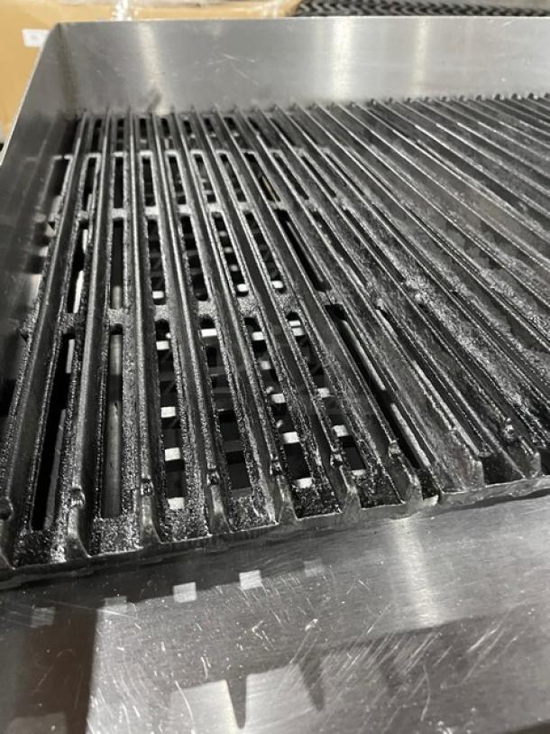 Apexra stainless steel gas countertop char broiler with black grates, back and side splash, on legs; commercial-grade.