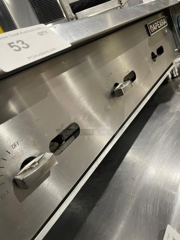 Apexra commercial stainless steel gas char broiler with back and side splash. Features control knobs, on countertop legs.