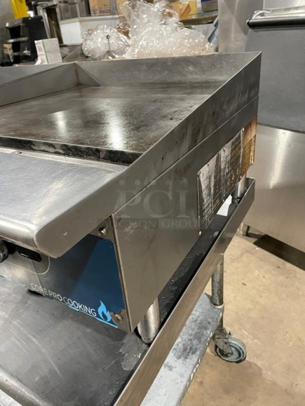 Core Pro Cooking stainless steel 24" flat griddle, natural gas, model CP-G24-M. Features back and side splash, on legs.