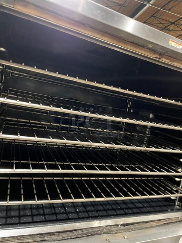 Southbend SL-Series stainless steel double convection oven, gas-powered, thermostatic control, wired racks, on casters.