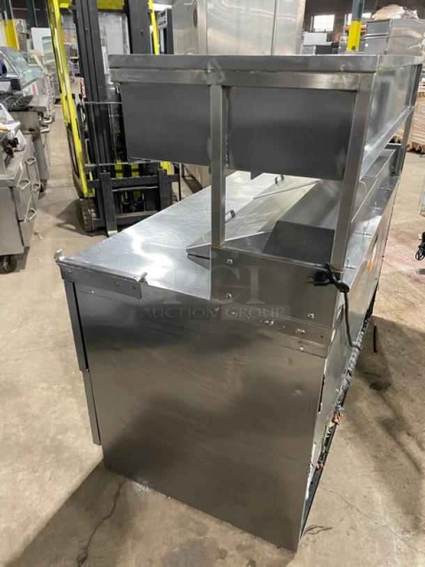 Delfield stainless steel 4-drawer refrigerated prep table, model UCD4464N12DD5, with enclosed overhead storage.