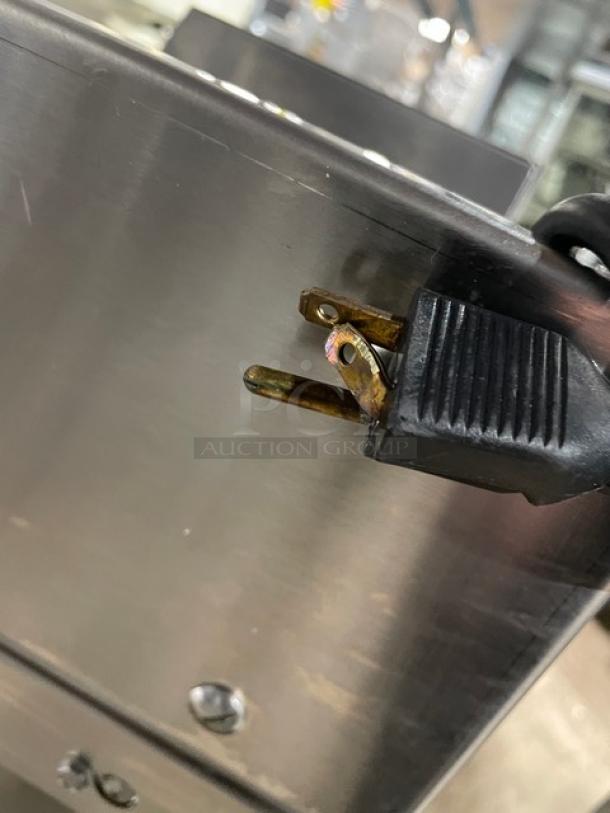 Delfield Model UCD446N-12-DD5 stainless steel 4-drawer refrigerated prep table with plug detail, showing minor wear.