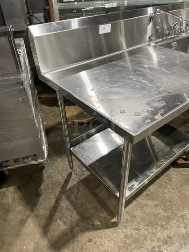 Custom commercial stainless steel single compartment sink with backsplash, swivel spout faucet, and dual-sided undershelf on legs.
