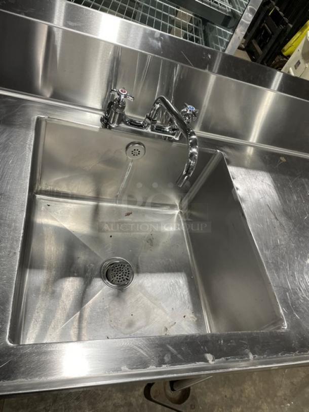 Custom commercial stainless steel sink with backsplash, swivel spout faucet, undershelf, and legs. Single compartment.